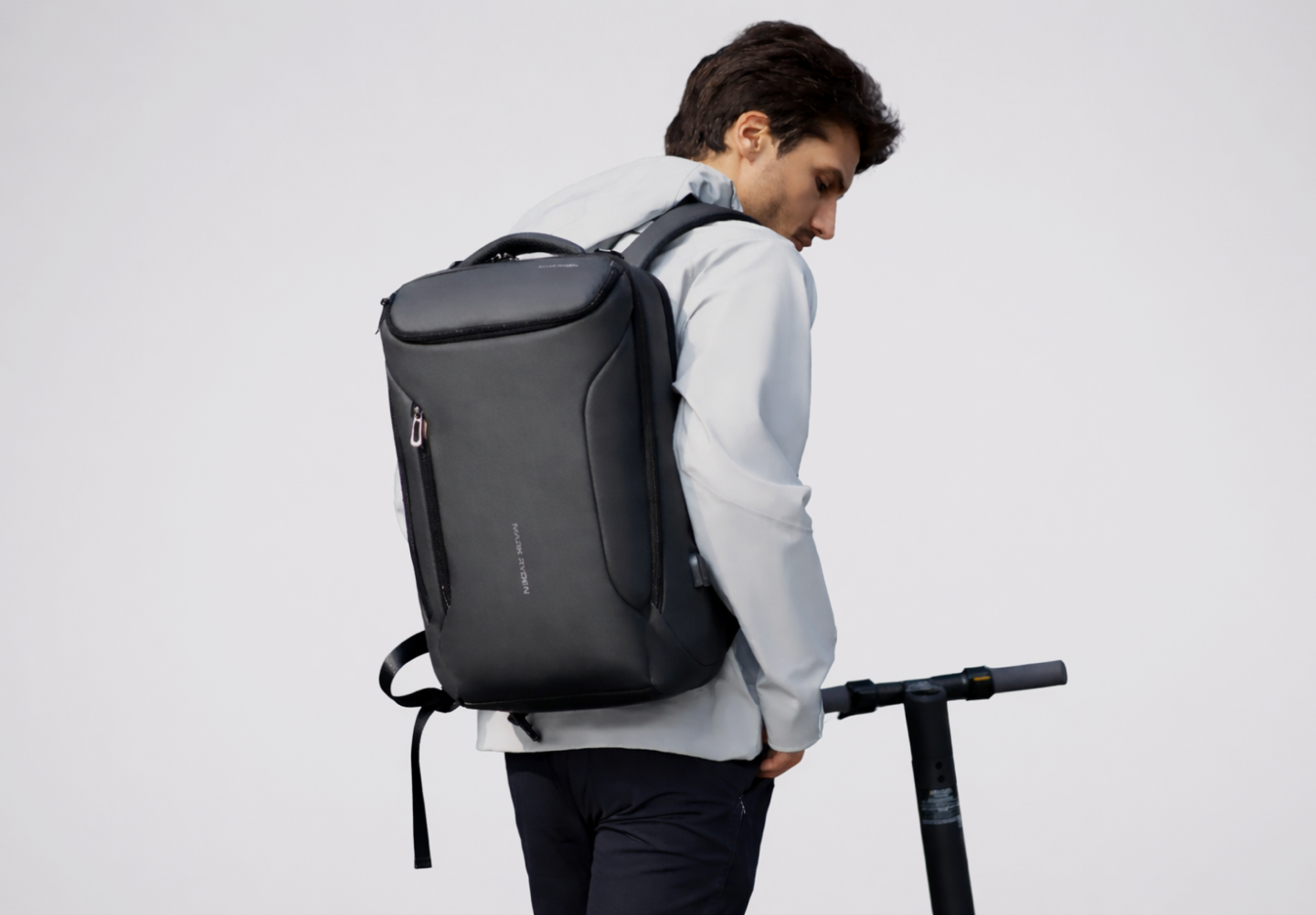 Traveller carrying a backpack with heavy items worn separately